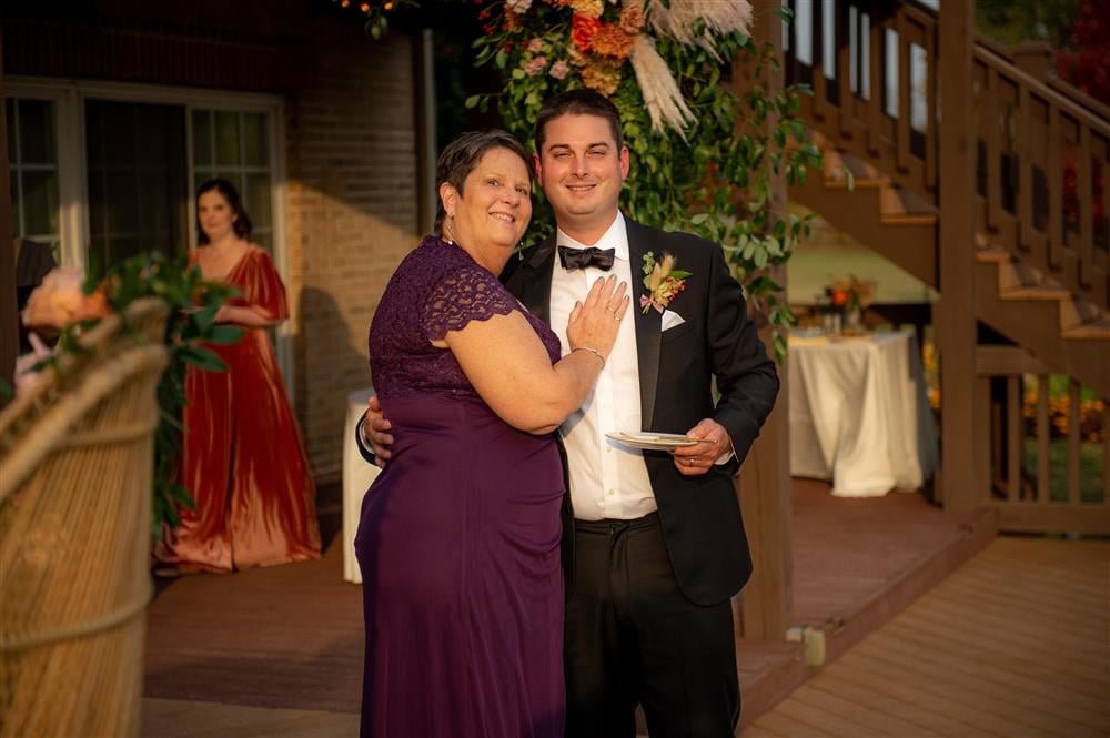 A well dressed woman and man pose for a photo